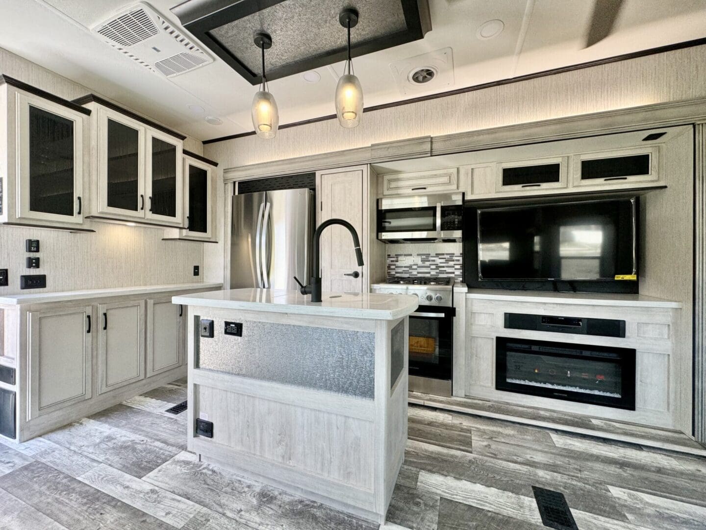 A kitchen with white cabinets and black appliances.