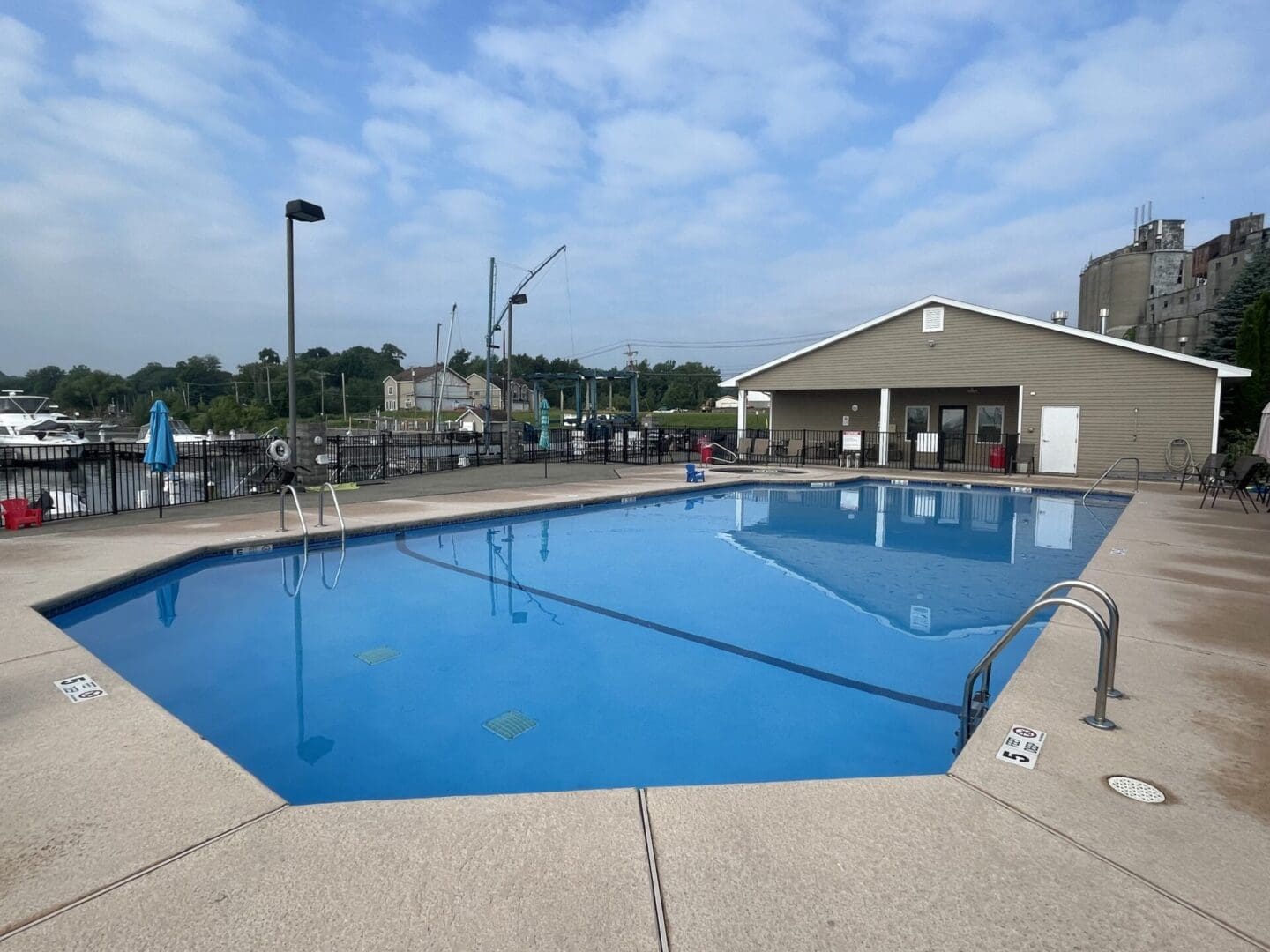 A pool with a blue water and a building