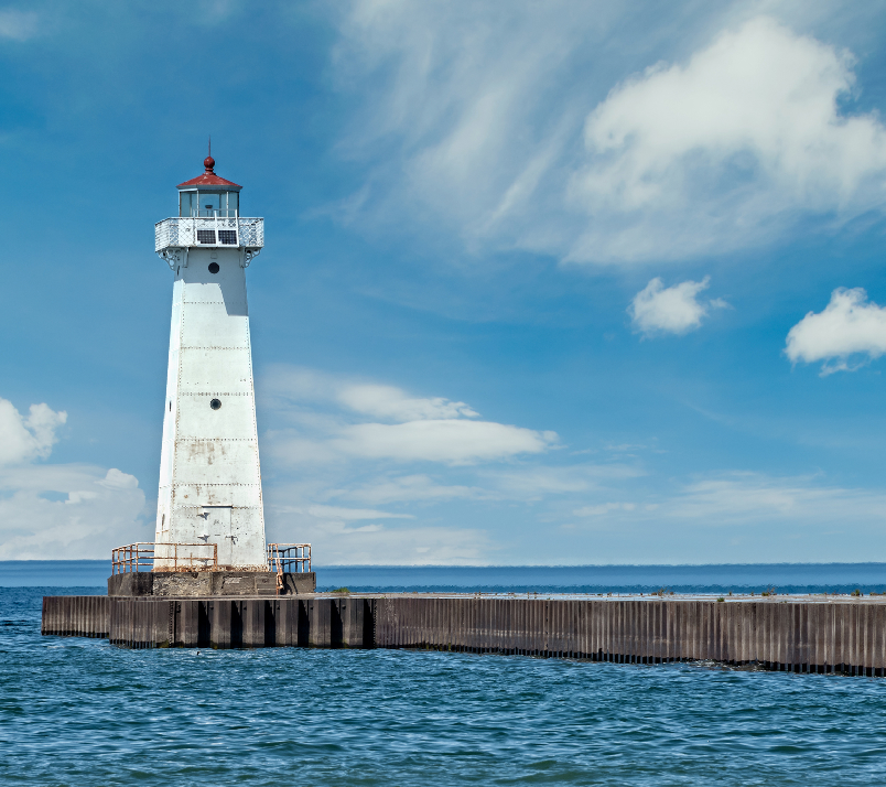 A lighthouse is shown on the water.